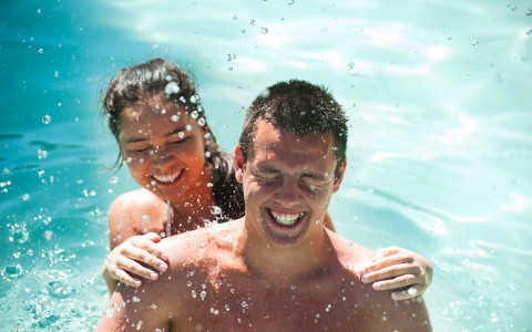 Couple being splashed with water 