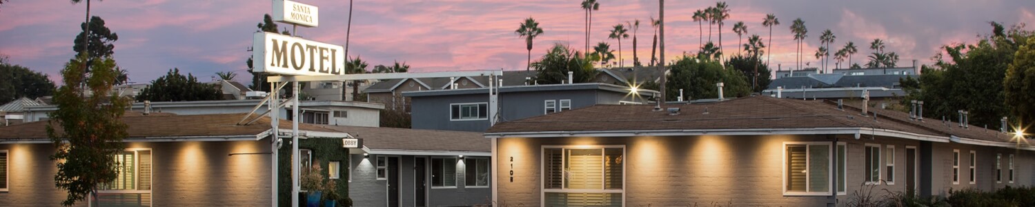 motel exterior with pink sky at sunset