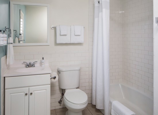 Guest bathroom with white subway tile and blue wall