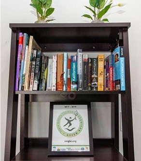 Wooden bookshelf with green certificate award