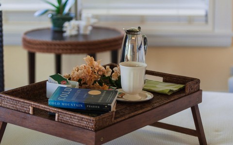 little wooden tray with snacks and a book
