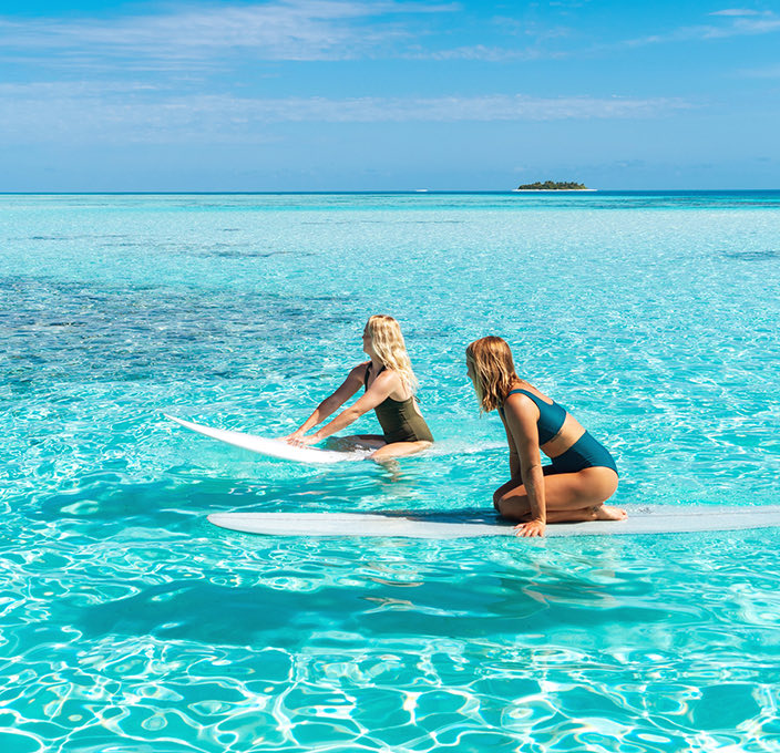 two ladies enjoying the day doing some surf