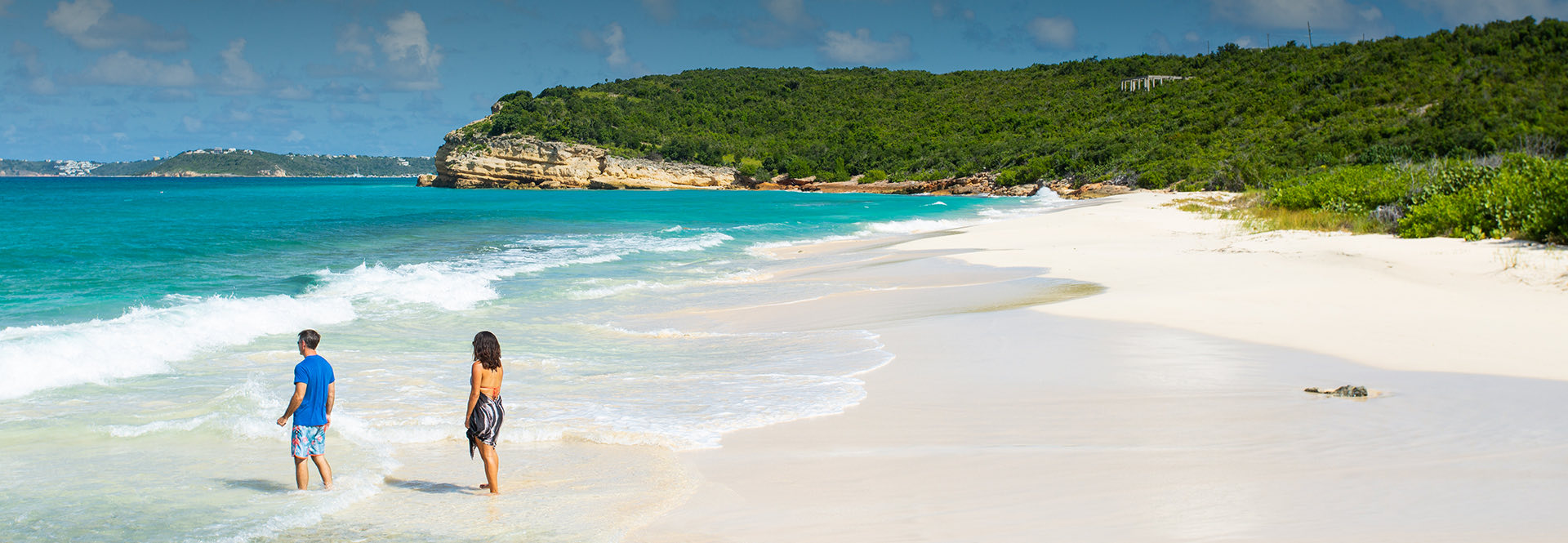 panoramic view of a beautiful beach and a couple looking at the sea