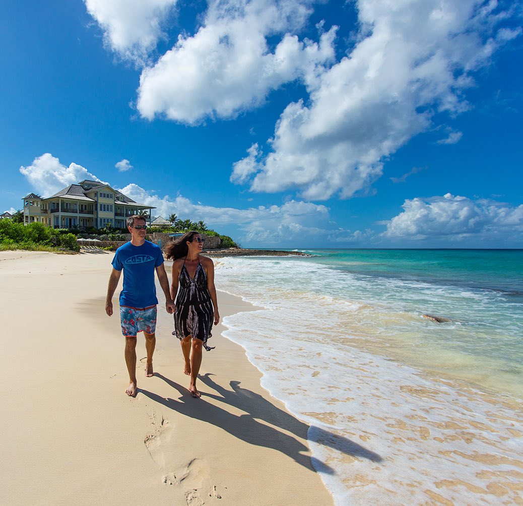 couple walking in a empty beach at daytime