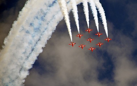 air show with airplanes & smoke in the air