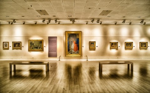 Gallery with benches & art hung on walls