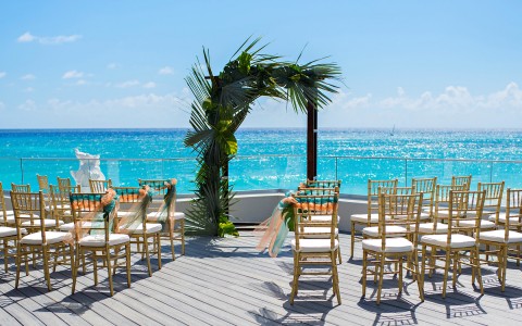 sundeck with gold chairs in wedding reception set up