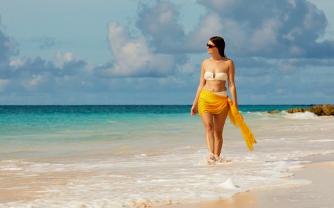 A beautiful woman walking at the beach
