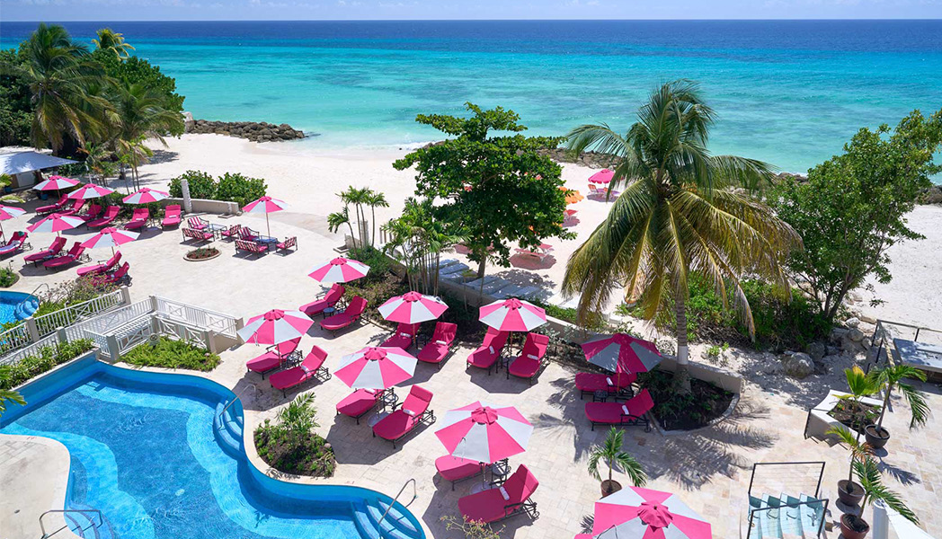 pool with pink loungers and pink umbrellas