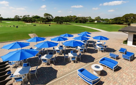 Aerial view of the exterior dining area with blue couch, chairs and parasols
