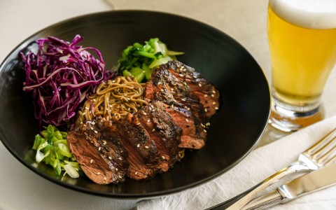 Beef medallions with cabbage, noodles and green vegetables
