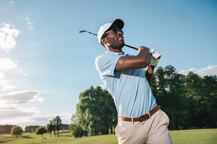 Man smiling after golf swing