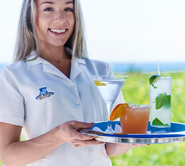 Waitress with white shirt carrying drink on a tray