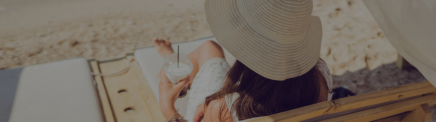 woman relaxing in deck chair with a glass