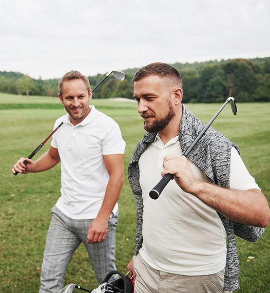 two golfers walking on golf course