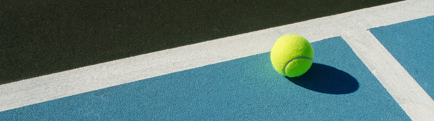 close up of a tennis ball on a tennis court
