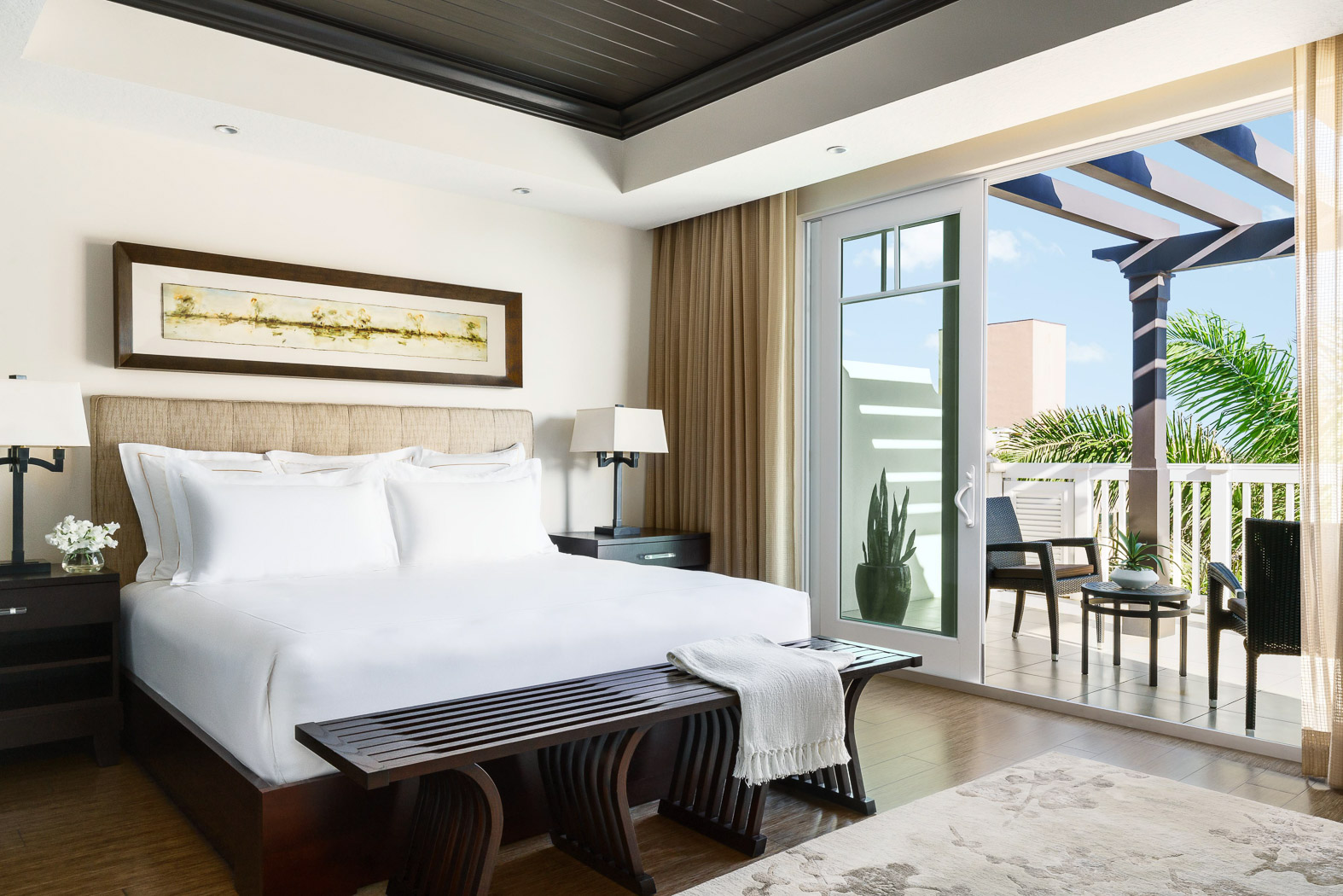 Presidential room with a king bed and a balcony on one side