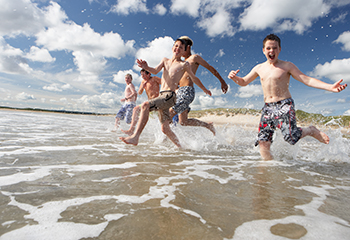 kids running towards the ocean