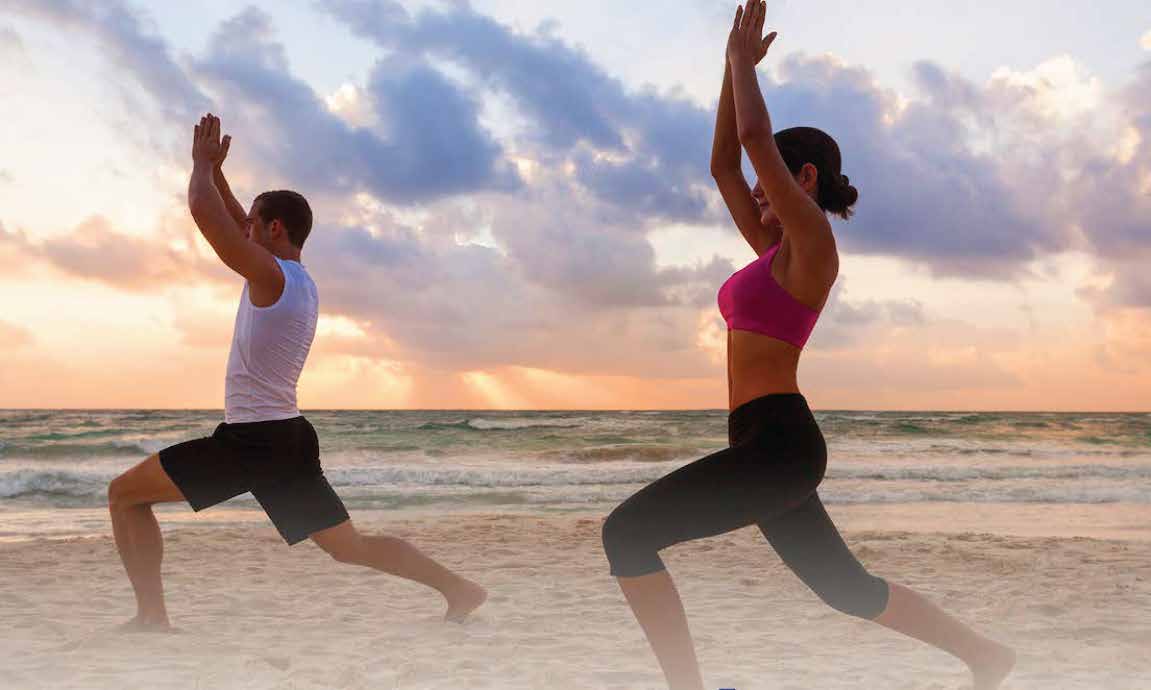 vinyasa yoga as the sun rises on the beach