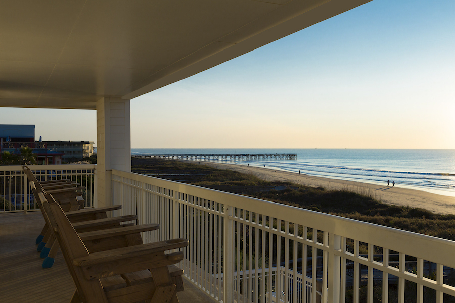 Chairs on balcony overlooking the beach