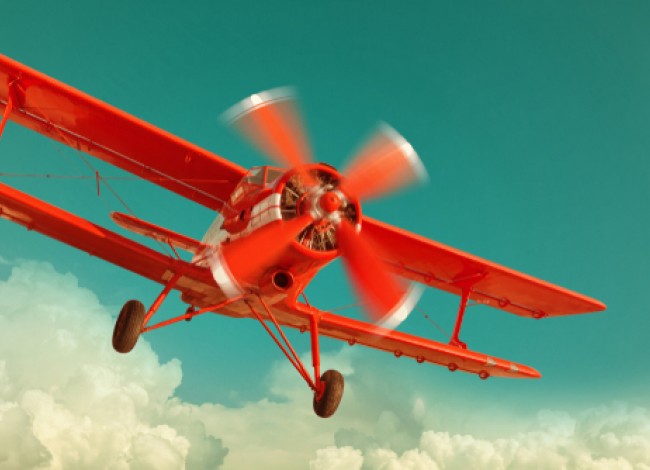 retro red biplane in the sky