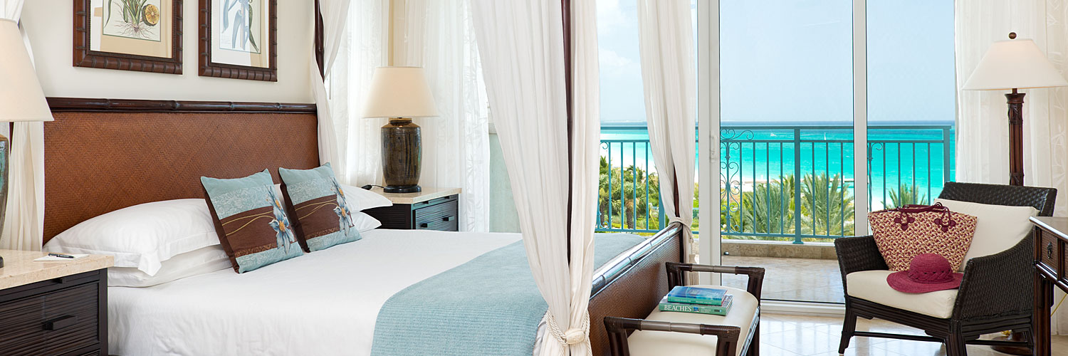 Guest room with canopy bed and oceanview