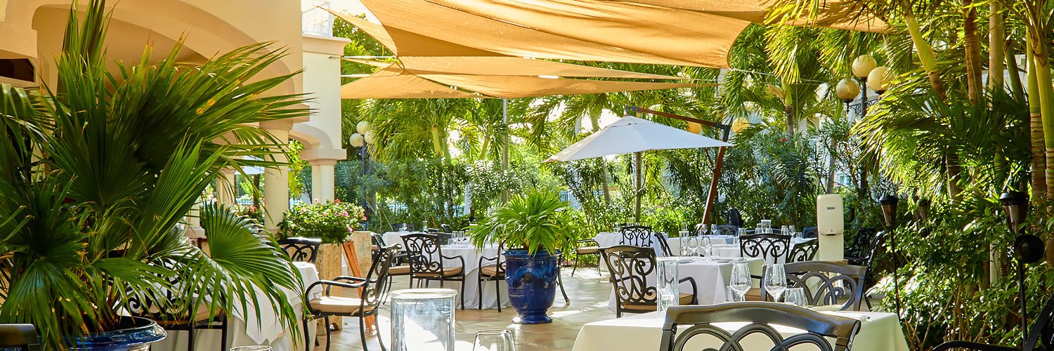 Outdoor dining area under yellow awnings