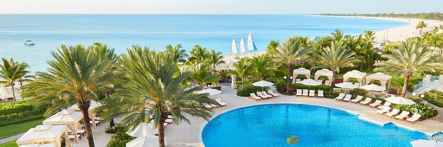 Aerial view of pool, palm trees and ocean