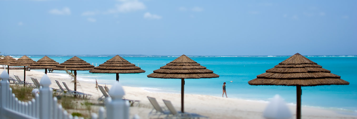 Beach with lounge chairs and umbrellas