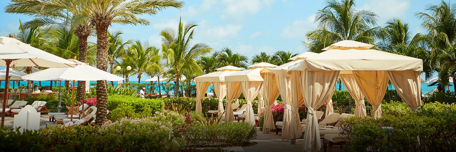 Covered lounge cabanas by palm trees