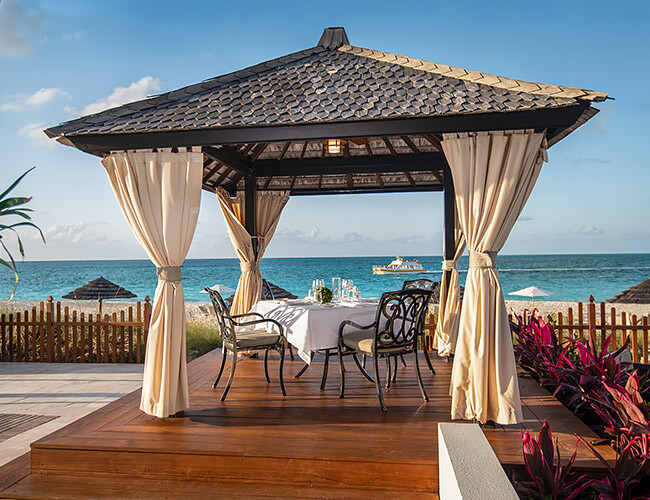 private dining table under beachside cabana