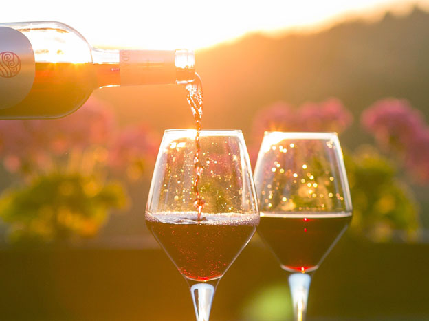 Two glasses of wine being poured
