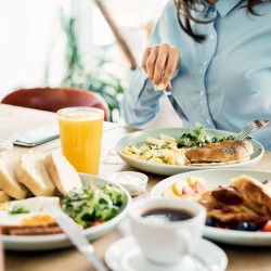 a woman eating her lunch with a close up of the array of fresh foods