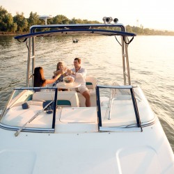 three friends toasting on a boat after a good day on the water