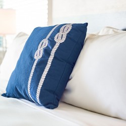 a close up of a sham pillow on a bed