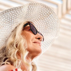 a woman in a white hat and sunglasses