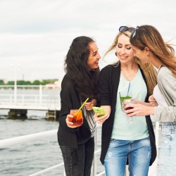 three women hanging out around the pier
