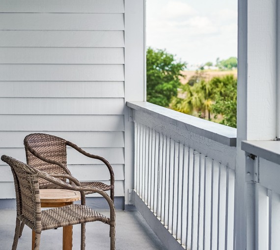 two wicker chairs on a balcony
