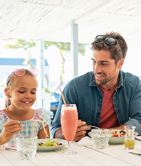 a man and his daughter dining at a resturant