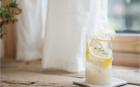 photo of lemonade in a glass on a window sill