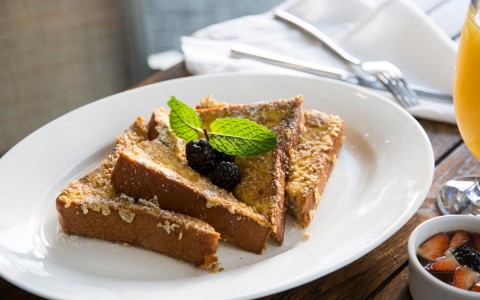 french toast dish with blackberry garnish