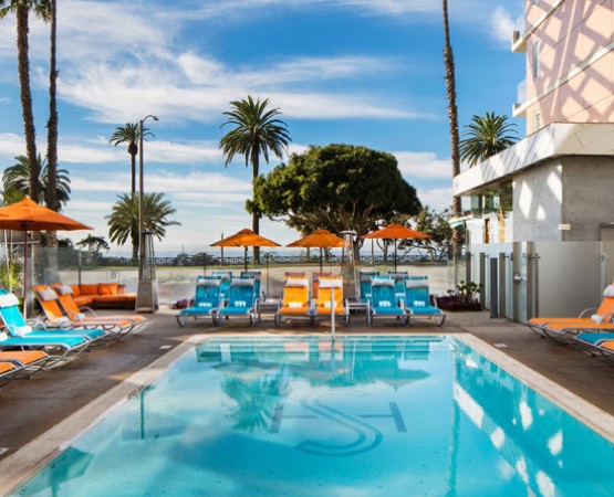 pool image with blue and orange lounge chairs 