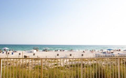 a beach with people and umbrellas