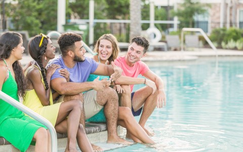 young people sitting by the pool