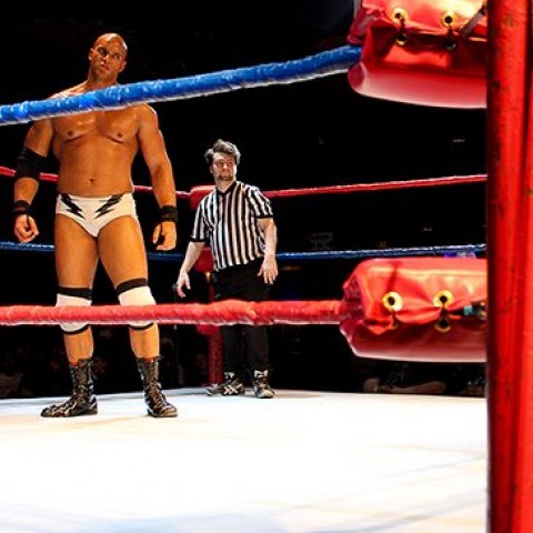 man and referee in a wrestling ring