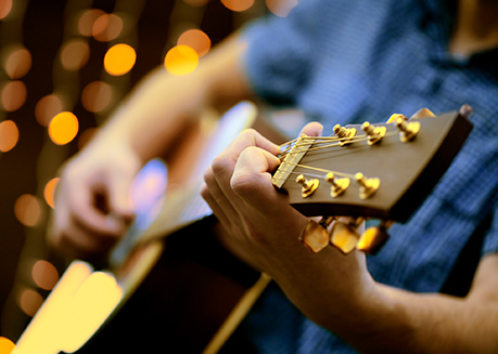 Close up of man playing guitar