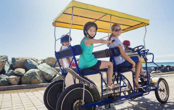 family on 4 person peddle car
