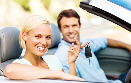 man and women riding in convertible
