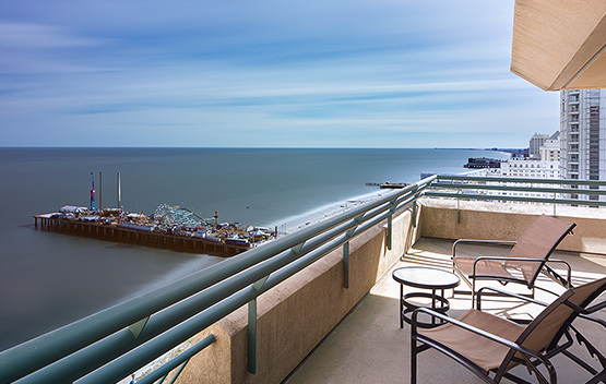 Balcony with lounge chairs overlooking the water