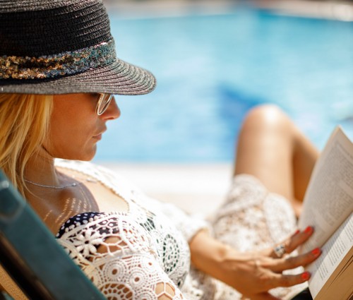 sch gallery woman reading book by the pool 